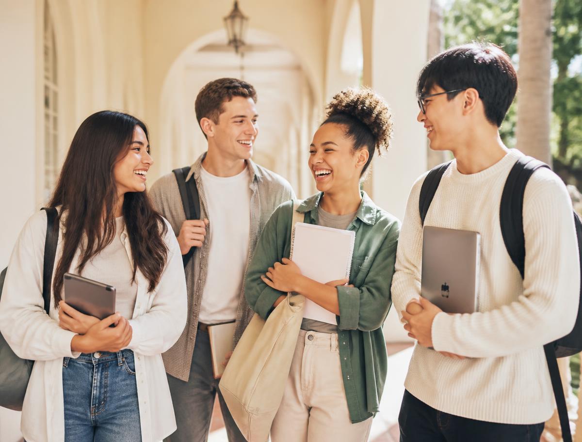 Happy university students laughing together on campus